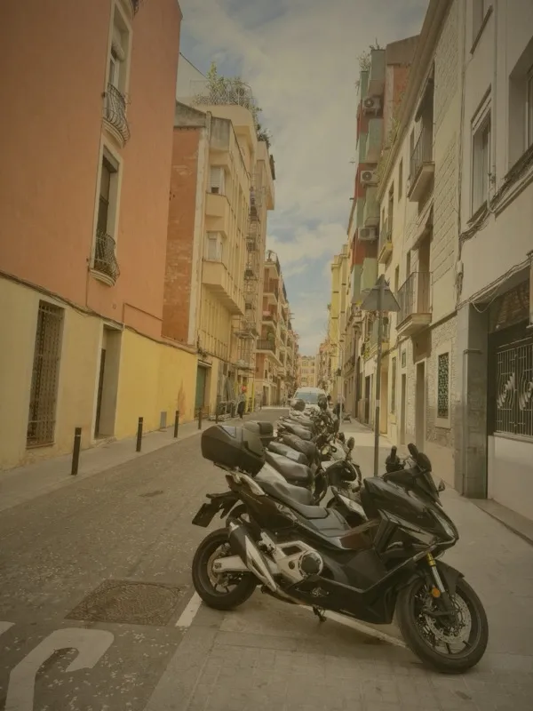 Motorcycles parked on a colorful Barcelona side street